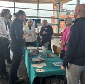 Photo of NRW staff talking with Senedd members around a table