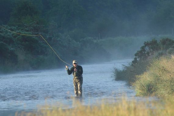 Man fly-fishing in a river Man fly-fishing in a river