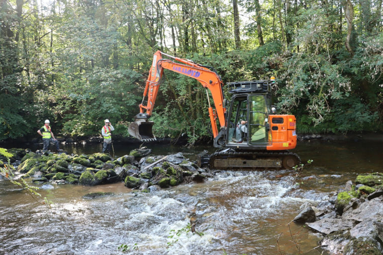 Excavator on the Tryweryn river Excavator on the Tryweryn river