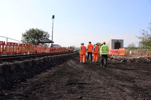 Four workers walking on site