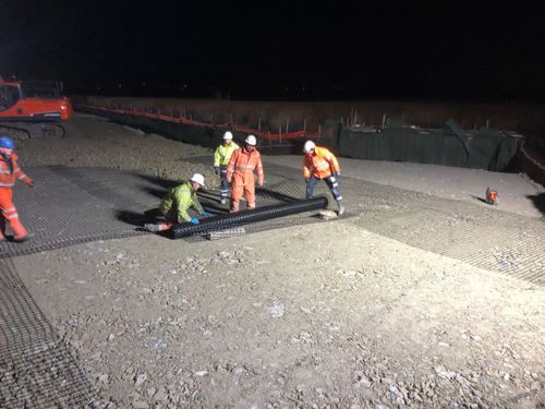 Four workers laying Geocell