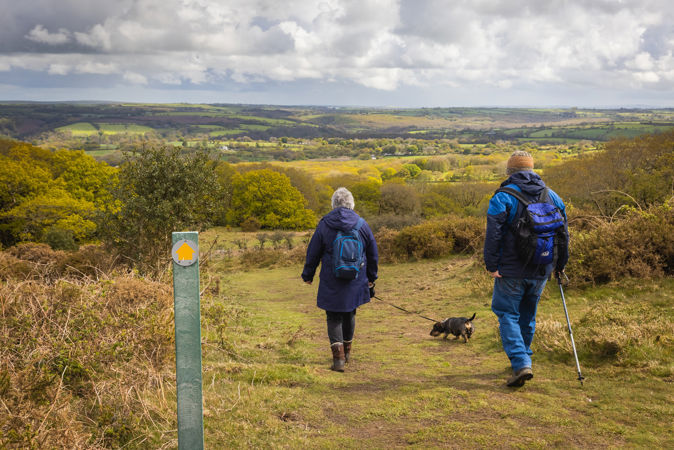 People walking on a public footpath in the countryside People walking on a public footpath in the countryside