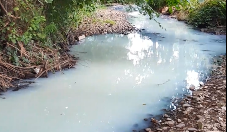 Discoloured water in river Nant yr Aber, Caerphilly 