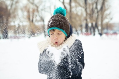 child plays in snow