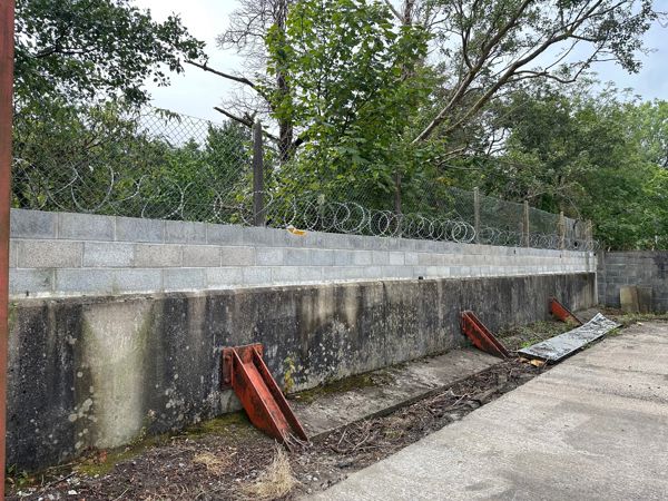 Block wall built on top of a flood defence Block wall built on top of a flood defence