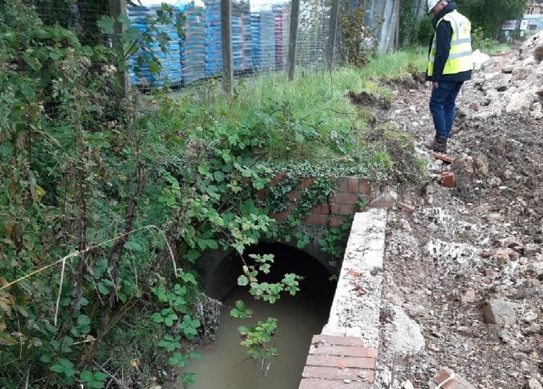 Polluted stream next to demolition material Polluted stream next to demolition material