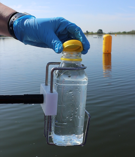 Picture shows the lid being put on a sample bottle
