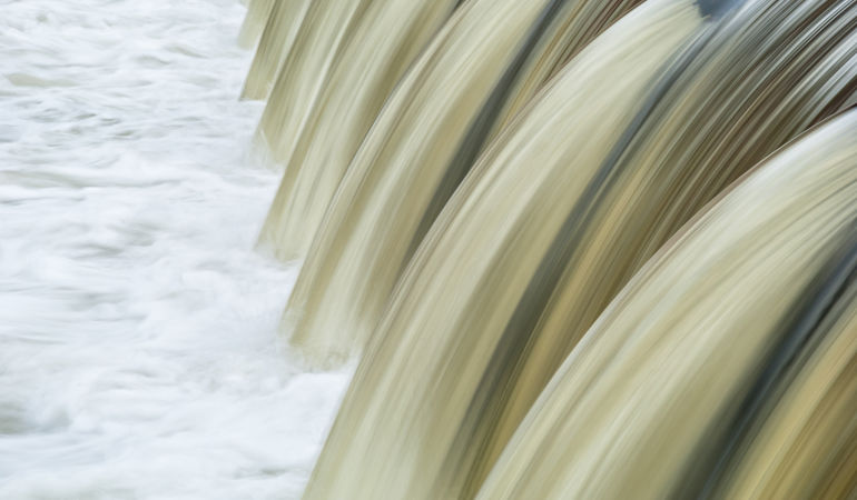 Water flowing over a weir Water flowing over a weir