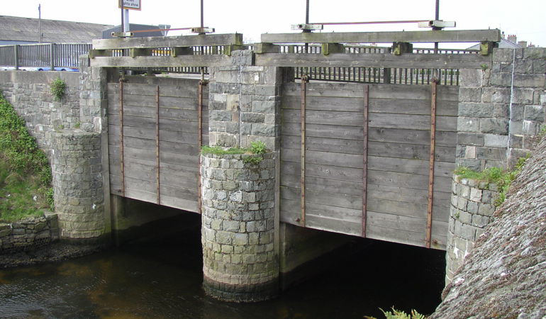 Penstocks on a bridge on the A497 road Penstocks on a bridge on the A497 road