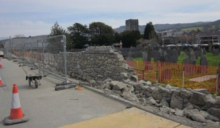Repairing the stone wall in Dolgellau to improve the flood defences Repairing the stone wall in Dolgellau to improve the flood defences