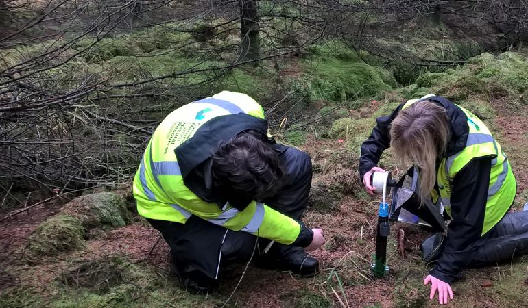 Two NRW staff members measuring the Dipwell Two NRW staff members measuring the Dipwell