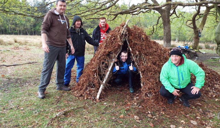 A group of people outsides making a tree canopy A group of people outsides making a tree canopy