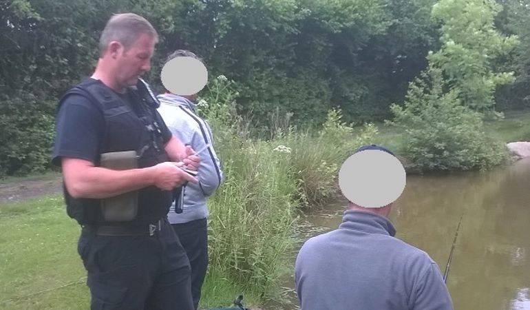 NRW enforcement officer checking rod licences NRW enforcement officer checking rod licences
