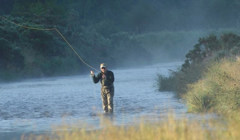 Man fly-fishing in a river