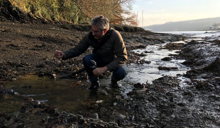 A man collecting a water sample A man collecting a water sample