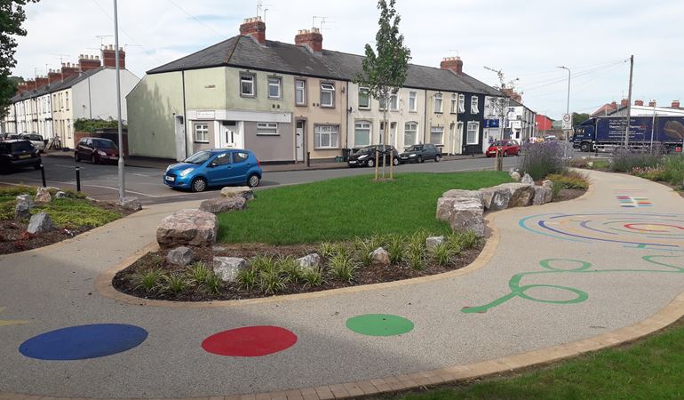A photo of Albany Street in Newport showing a new foot path with a colourful play trail with shapes and lines on the ground