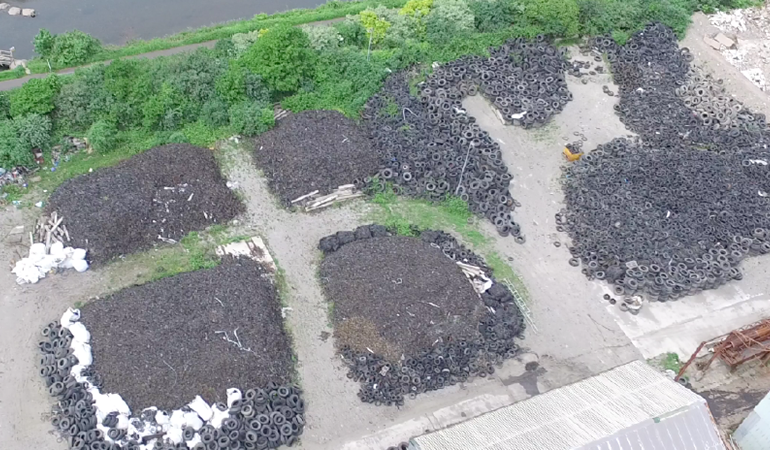 An aerial image of piles of waste tyres