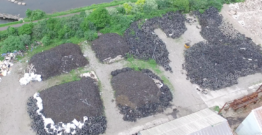 An aerial image of piles of waste tyres