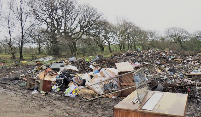 A pile of waste illegally deposited on land in Felinfoel, Llanelli