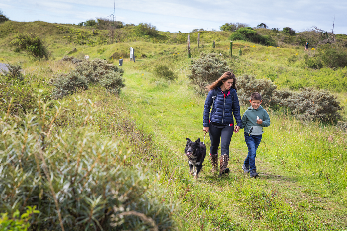 Woman, boy and dog walking at Pembrey Forest