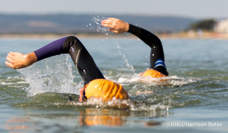 Two people open water swimming 