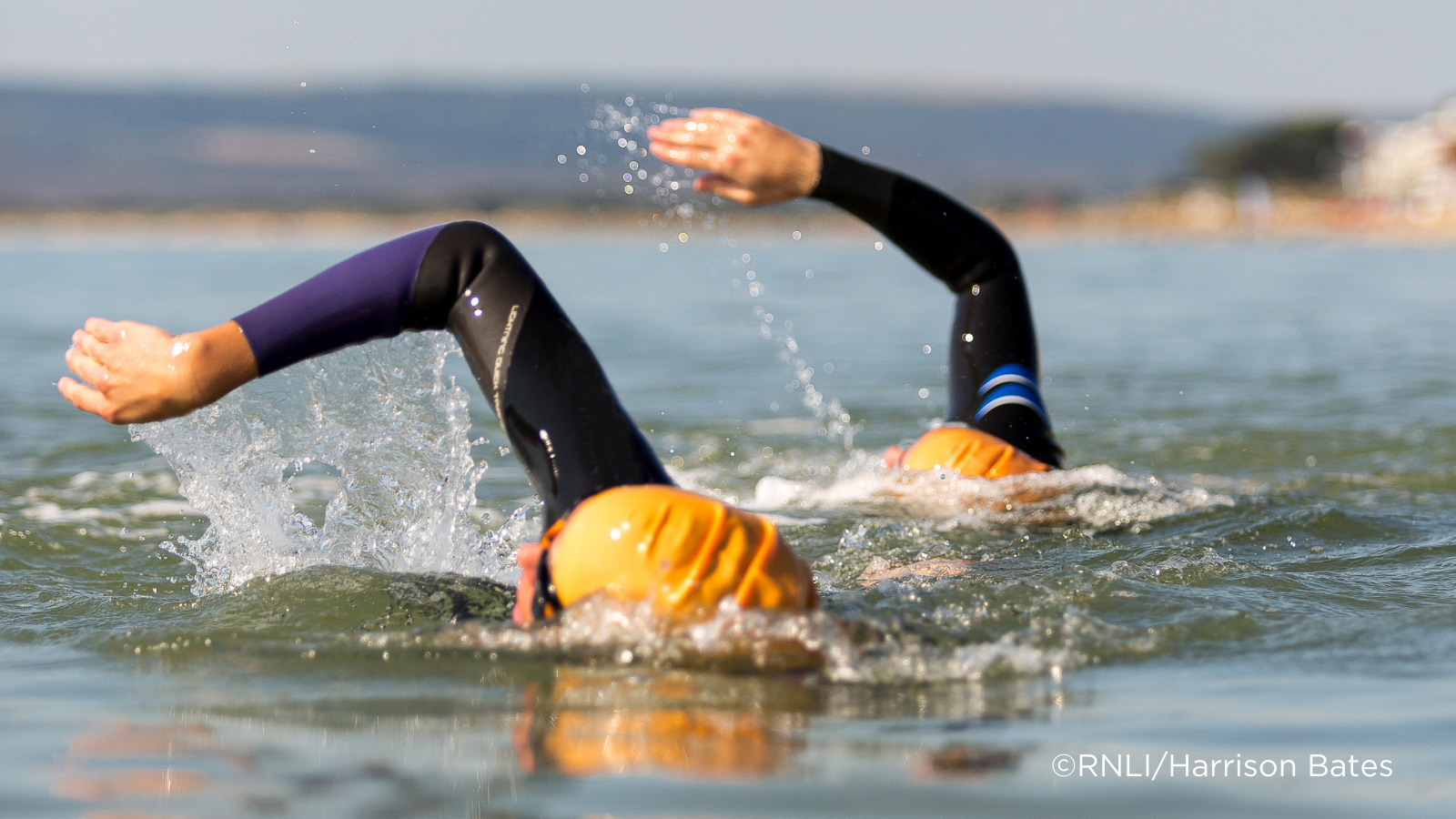 Two people open water swimming 