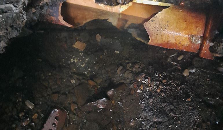 The damaged pipe which caused the incident at the river bed under a bridge
