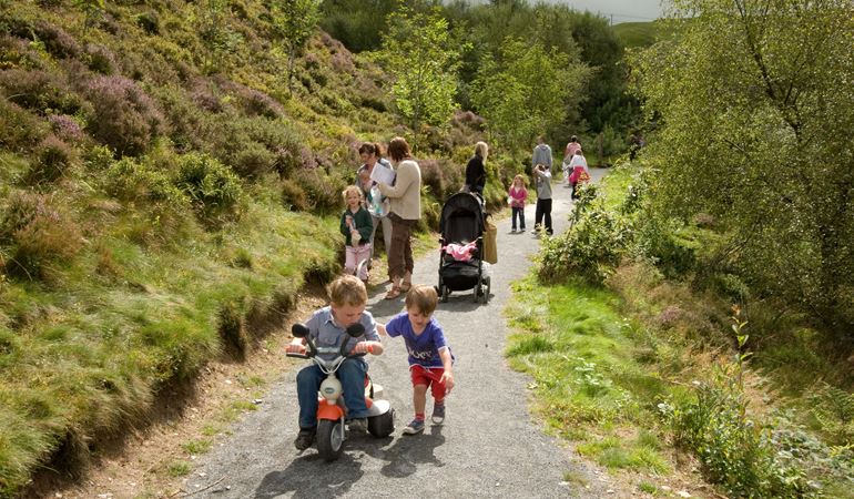 Families walking on a path at Bwlch Nant yr Arian