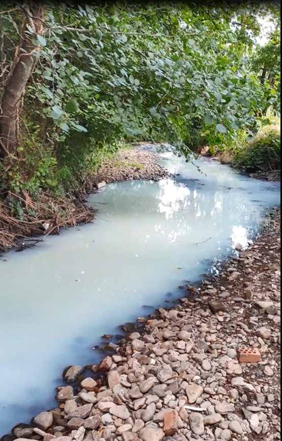 Discoloured water in river Nant yr Aber, Caerphilly 