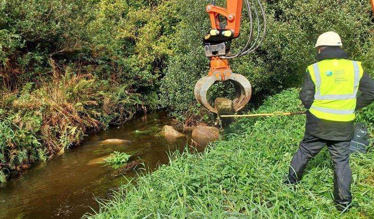 Long reach machinery placing boulders – credit NRW