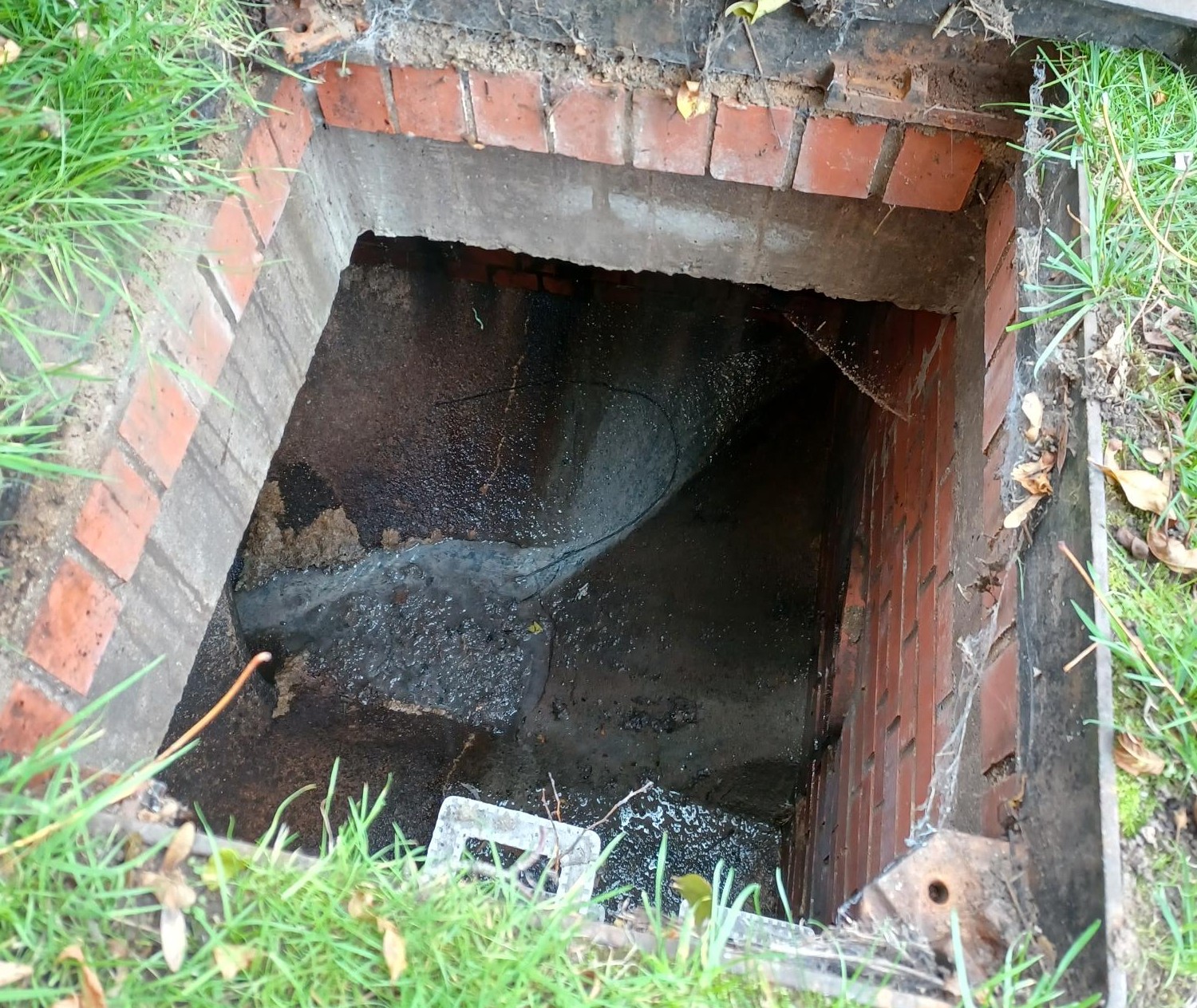 Grey water flowing through a surface water network inspection chamber 