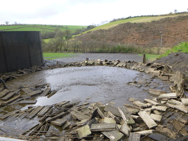 Collapsed slurry store with slurry running into the stream Collapsed slurry store with slurry running into the stream